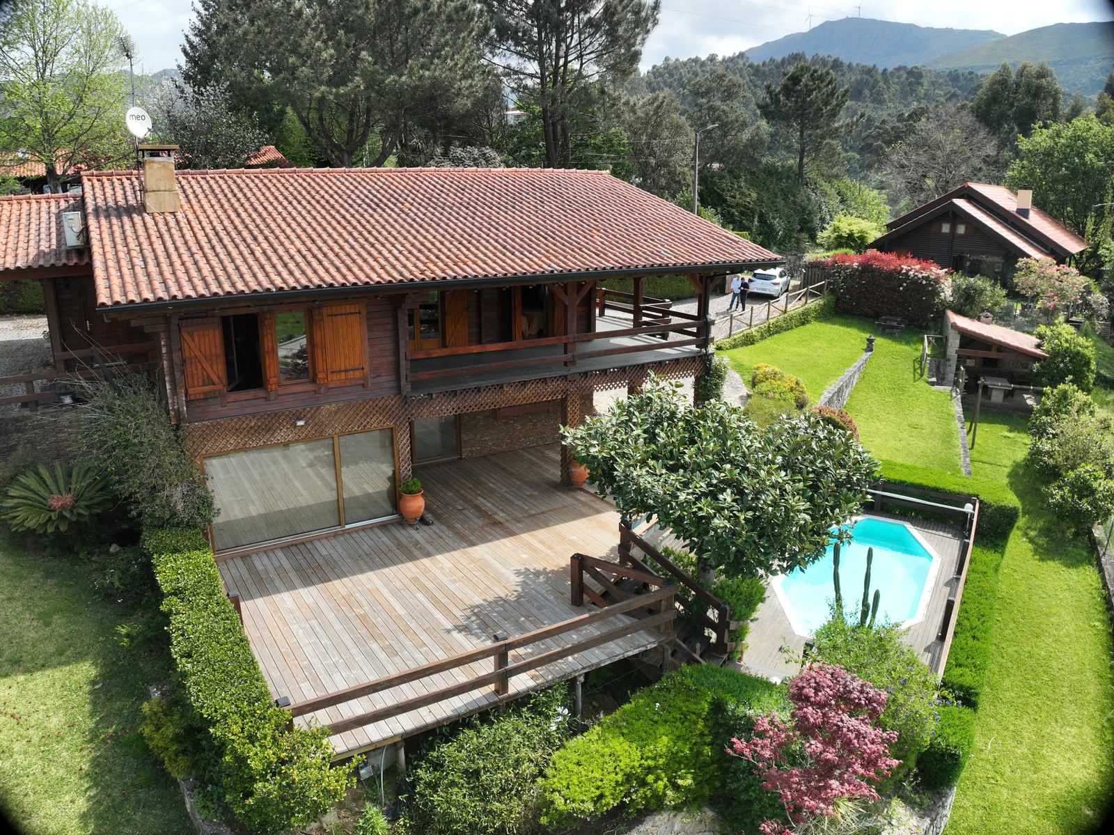 Timber chalet with deck, pool and garden, seen from above